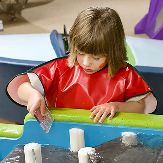 child playing with the water table